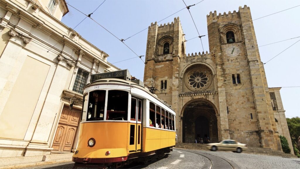 Tram 28 passing in front of Sé de Lisboa